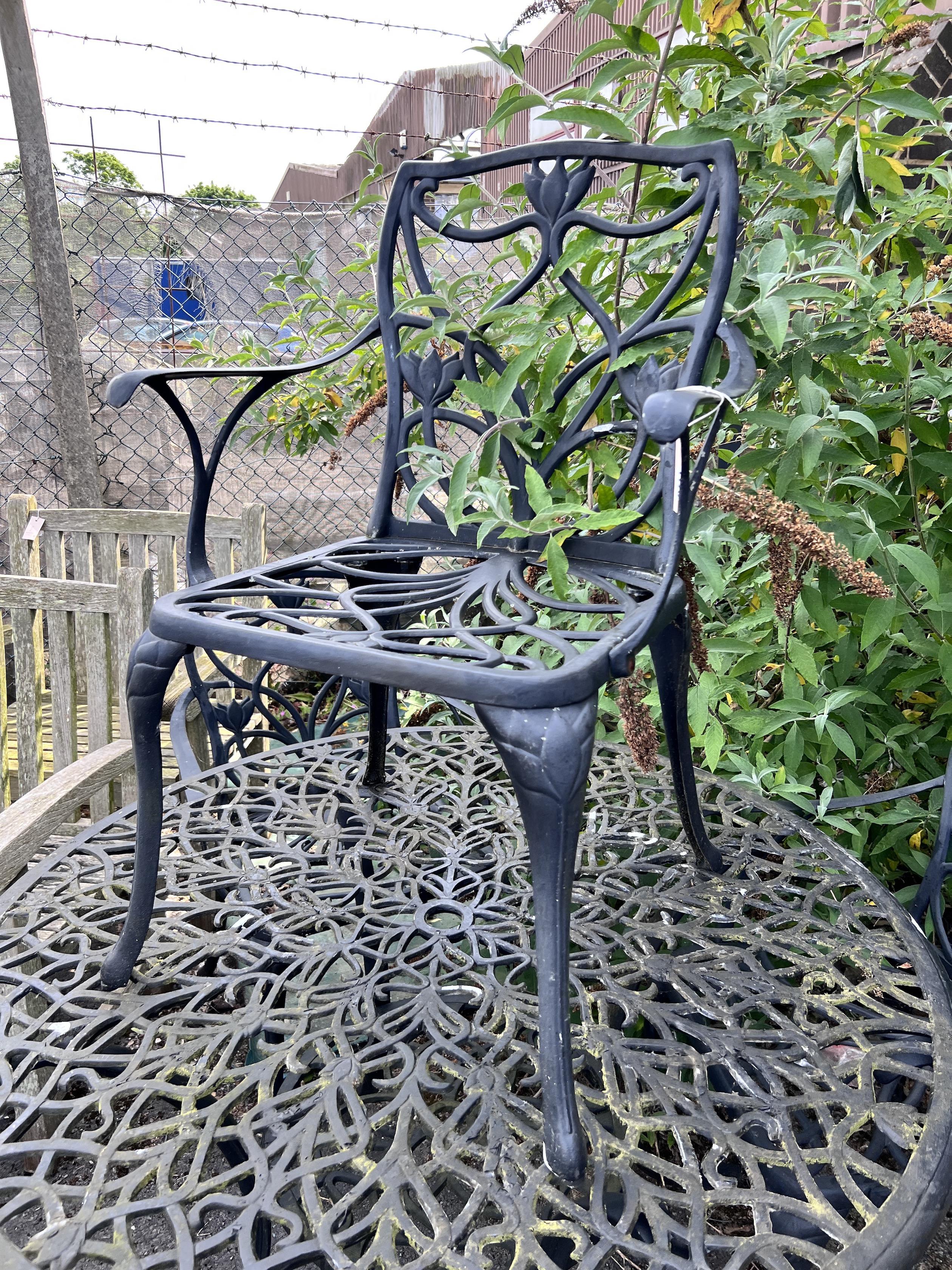 A circular painted aluminium garden table and three chairs, table 120cm diameter, height 72cm